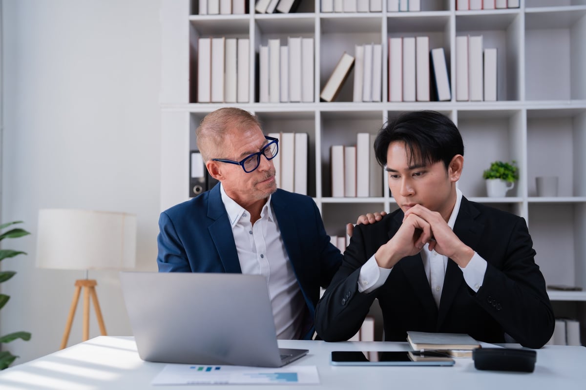 Experienced mentor supporting a young colleague, representing the founder's commitment to mentorship and guidance
